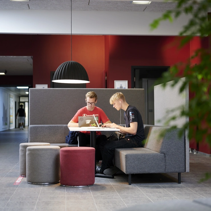 Two students in a lounge area at EUC Syd