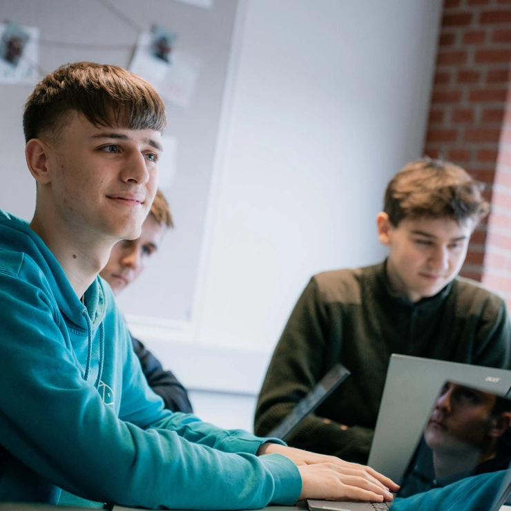 Three students with laptops