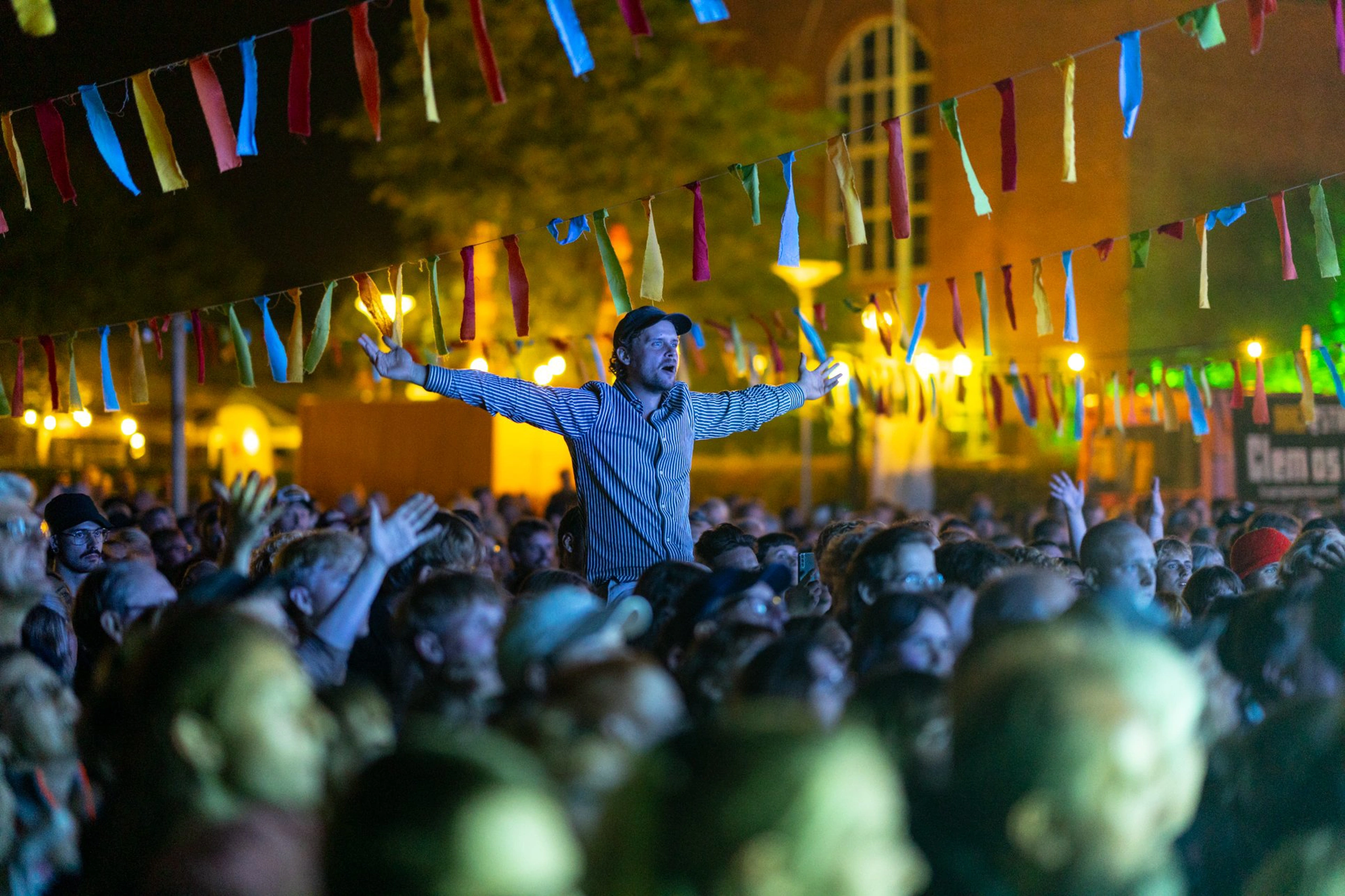 Concert attendees with a man on someone’s shoulders